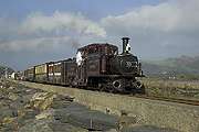 ‘Merddin Emrys’ gleams in the sun as the mixed train heads out along the Cob.       (15/10/2005)