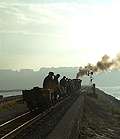 ‘Palmerston’ and the slate waggons head into the sun along the Cob.       (16/10/2005)