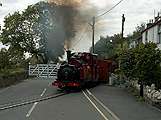 ‘Prince’ runs across the road at Penrhyn with a train for Blaenau Ffestiniog.       (16/10/2005)