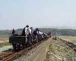 A collection of happy travellers set out along the Cob riding the slate waggons.   (01/05/2004)