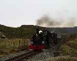 ‘Blanche’ and ‘Linda’ leave Moelwyn Tunnel and cross the footpath by the Archer Dam   (12/10/2002)