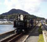 Taliesin and an up vintage train departs from Porthmadog and runs along the Cob   (12/10/2002)