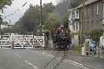 Nosing out across Penrhyn crossing, ‘David Lloyd George’ and the 1950s train.   (26/09/2004)