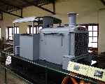 An early Hudswell Clarke narrow gauge locomotive on display inside the locomotive shed at Armley Mills.   (19/04/2003)