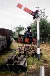 ‘Melior’ is framed by the starter signal (which curiously is off) as it runs light into Sittingbourne station   (28/07/1996)