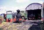 Kerr, Stuart ‘Melior’ stands in front of Bagnall 0-6-2Ts ‘Triumph’ and ‘Alpha’ in Kemsley shed   (09/08/1997)