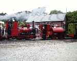 Two red locomotives, ‘Douglas’ masquerades as ‘Duncan’ and former Corris ‘Sir Haydn’, Tywyn Wharf.   (29/07/2001)