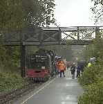 The crew of Garratt 143 hand over the token for the Dinas to Waunfawr section as they run into the platform.   (11/09/2004)
