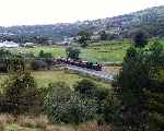 138 ‘Millennium’ has just crossed Pont Cae Hywel with a train for Rhyd Ddu   (27/09/2003)