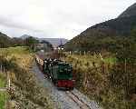 NGG16 138 ‘Millennium’ runs quickly down the slope through Bryn Gloch caravan site   (27/09/2003)