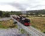 143 approaches Bettws Garmon, the rear of the train is crossing the replacement Pont Bettws   (27/09/2003)