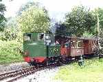 No 823 ‘Countess’ runs over the level crossing and into Castle Caereinion station   (24/08/2002)