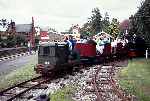 Cabless 20HP Ruston tractor No 6 and Hunslet ‘Elin’ top and tail a passenger train   (04/09/1993)